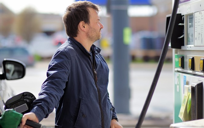 Middle Age Man Filling Gasoline Fuel In Car Holding Nozzle